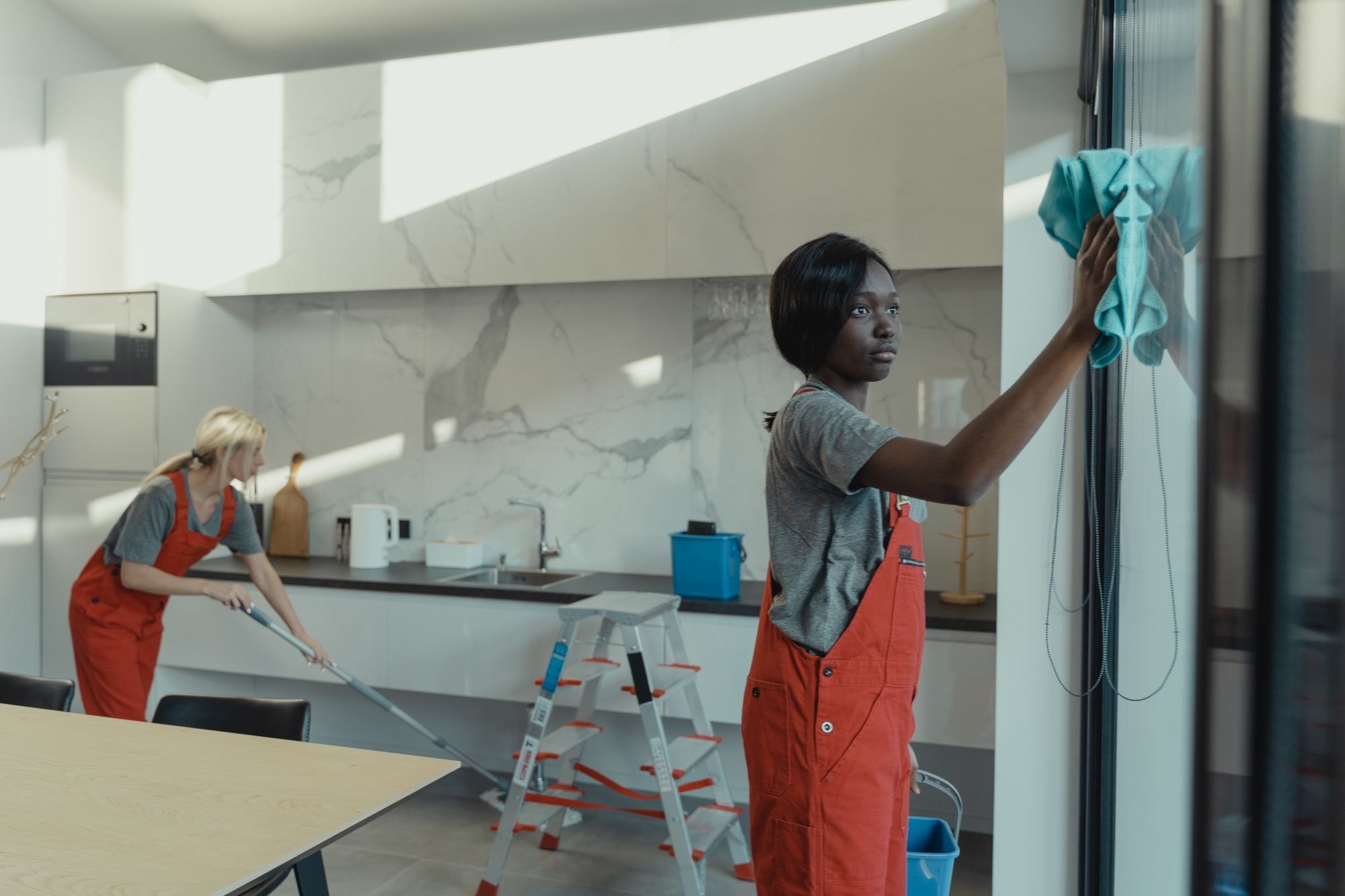 Cleaners at work in a modern kitchen